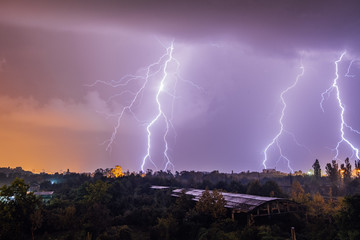 Naklejka na ściany i meble Lightning strikes during thunderstorm over the city