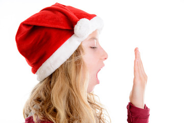 girl with Santa- Claus cap is yawning