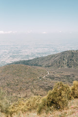 Vesuvius volcano in Italy. Top of the mountain, view of the crater and the surrounding area. High view, Naples and Pompeii below. The nature around the volcano