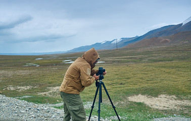 Photographer taking photo on highest mountain