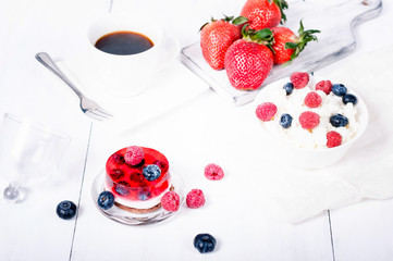 Cottage cheese with blueberry and jelly cheesecake on a white wooden background. Proper nutrition