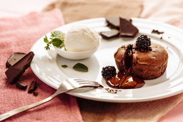 chocolate Fondan with syrup and ice-cream on a plate decorated with mint leaves