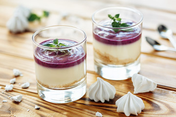 Cake with cream cheese and fresh blueberries in glass cup