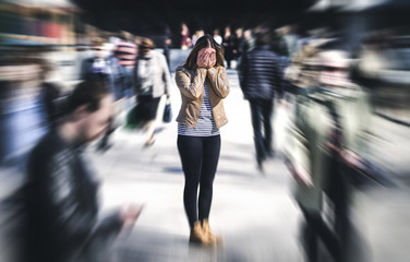 Panic attack in public place. Woman having panic disorder in city. Psychology, solitude, fear or mental health problems concept. Depressed sad person surrounded by people walking in busy street. - obrazy, fototapety, plakaty
