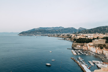 Naklejka na ściany i meble Views of the city of Sorrento in Italy, panorama and top view. Night and day, the streets and the coast. Beautiful landscape and brick roofs. Architecture and monuments of antiquity.