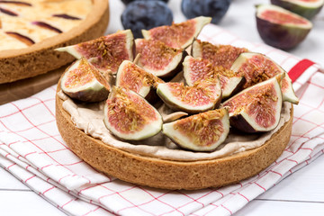 French Tart with Fruits Curd and Merengue Decorated with tasty Figs on White Wooden Background Pastry Tasty Homemade Tart and Pie with Plums