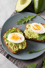 Avocado toasts with eggs and salad on breakfast