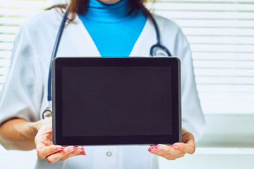 Doctor working on a digital tablet with copy space