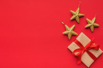 Gift box with three golden stars on red background