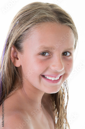 "Studio shot of young little 9-10 year old girl smiling in ...