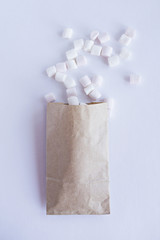 Kraft paper bag and marshmallows on the white