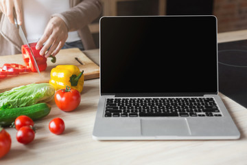 Laptop with blank screen on kitchen table
