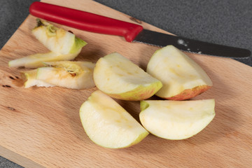 Close up of apple pieces lying on a cutting board