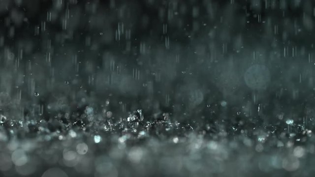 Heavy rain on dark background, shooted with high speed cinema camera at 1000 fps. 4K footage.