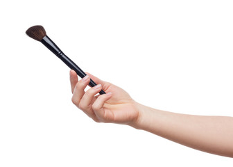 Cosmetic brush in female hand isolated on white
