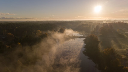 Fototapeta premium Morning smoke on the water Ulbroka lake Aerial drone top view Latvia