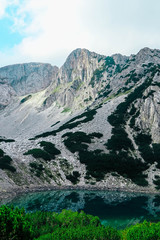 Amazing alpine lake in the high mountains. Beautiful fiord mountain, river, hiking scenic landscape, summertime.