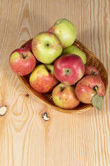 Naklejka na ściany i meble Basket full of ripe apples on a wooden table