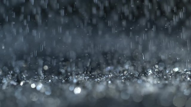 Heavy rain on dark background, shooted with high speed cinema camera at 1000 fps. 4K footage.