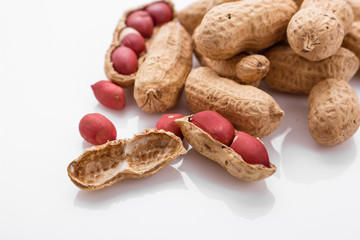 fresh peanuts on a white acrylic background