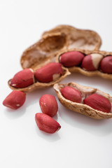 fresh peanuts on a white acrylic background