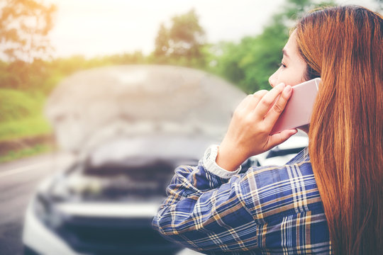 Young Woman Calling For Assistance With His Car Broken Down By The Roadside