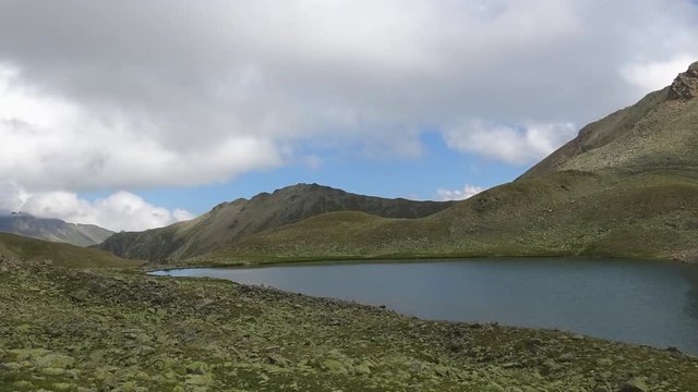 Time lapse lake scenes in mountains, national park Dombai, Caucasus, Russia, Europe. Summer landscape, sunshine weather, blue sky and sunny day