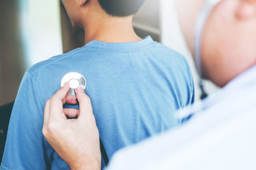 Fototapeta premium Doctor listening to patients breathing sound with Stethoscope