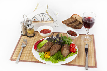 Cutlets with greens, tomatoes and cucumbers. Serve with black or white bread and a glass of red wine.