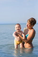 Mom with a baby on the sea