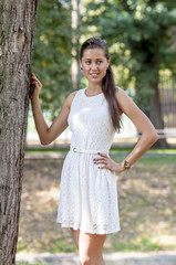 Young girl in a white dress in a summer park

