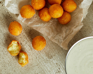 Fresh homemade cheese balls on wooden cutting board
