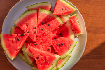 Fresh sliced watermelon on a plate close-up - top view