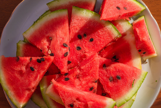 Fresh sliced watermelon on a plate close-up - top view