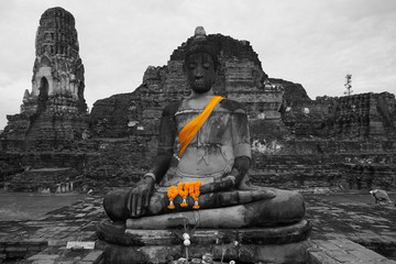 Buddha statue in black and white with yellow robe