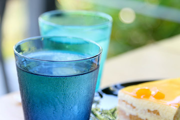 Cold water in a blue  transparent glass.