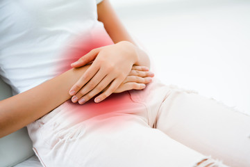The hands of women put on the belly. Because of abdominal pain. There are many causes like...
