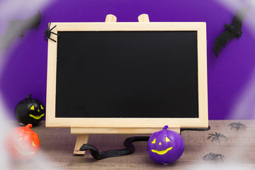 Halloween background concept. blackboard with decor pumpkin, bat, snake spider and spider web vignette
