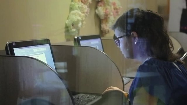 Hands of young child typing on keyboard in computer class