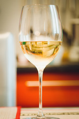 A glass with champagne, close-up, soft focus.