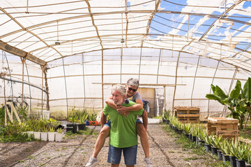 happiness for beautiful caucasian couple carrying out and enjoy the leisure activity outdoor. forever together concept while the man carry on his back the woman. youthful people with no limit age j