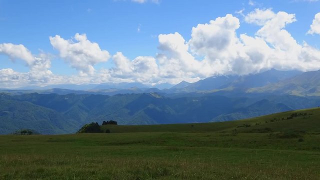 Time lapse mountains scenes in national park Dombai, Caucasus, Russia, Europe. Summer landscape, sunshine weather, blue sky and sunny day