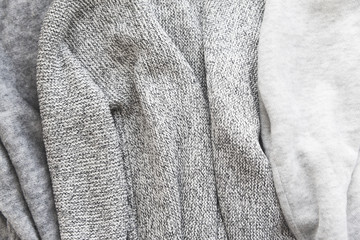 background of different shades of gray knitted sweaters
