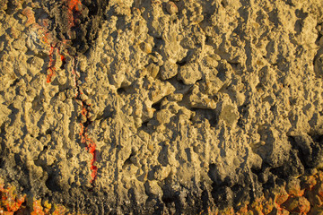The texture of the cement wall. The concrete wall is stained with paint. Detail of graffiti.