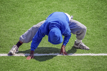 Fototapeta na wymiar Track and field athlete stretching