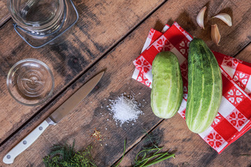 overhead flat lay image of cucumbers and ingredients to make refrigerator pickles