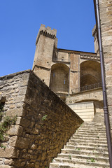 Spain, Navarre, Ujue: Detail view with stairs up to the famous church of Santa María in the city center of old small Spanish village with blue sky in background - concept travel religion history.