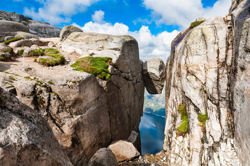 Kjeragbolten - famous landmark on Kjerag mountain, Norway. Summer landscape