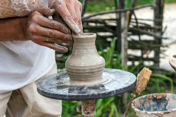 Human hands make a clay jug close-up. Sculptor's workshop. The sculptor makes a jug of clay close-up.