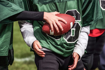 Football hand off in youth football game © soupstock